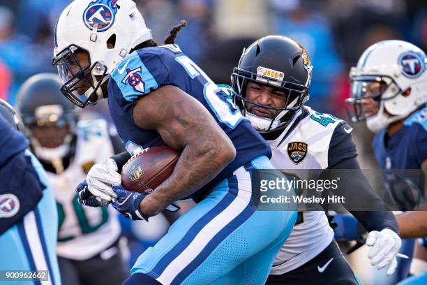 Barry Church of the Jacksonville Jaguars tackles Derrick Henry of the Tennessee Titans at Nissan Stadium on December 31, 2017 in Nashville,...