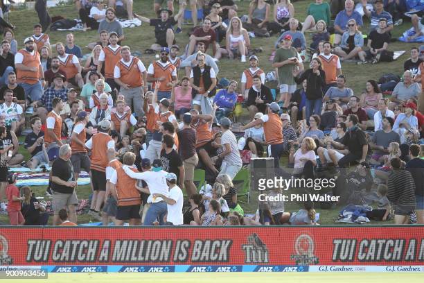 Fans attempt to catch a six one handed as part of the Tui Catch A Million promotion during game three of the Twenty20 series between New Zealand and...