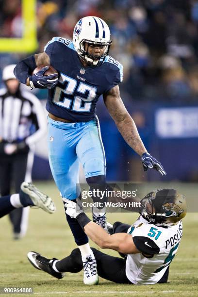 Derrick Henry of the Tennessee Titans runs the ball and breaks the tackle from Paul Posluszny of the Jacksonville Jaguars at Nissan Stadium on...