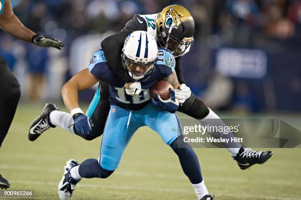 Rishard Matthews of the Tennessee Titans is tackled from behind by Barry Church of the Jacksonville Jaguars at Nissan Stadium on December 31, 2017 in...