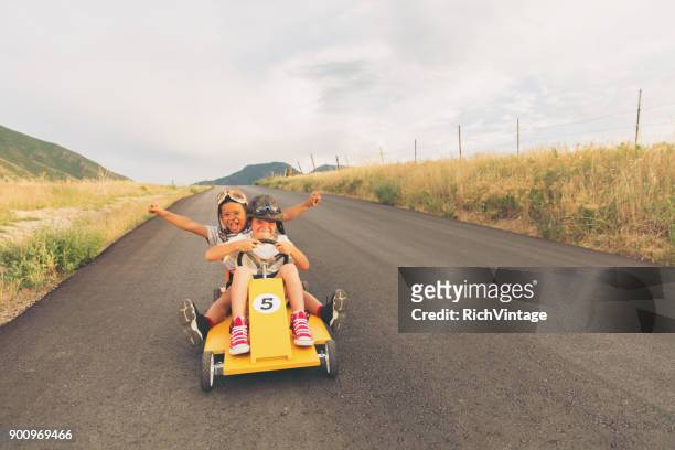 young boys racing homemade car - boy playing with cars stock pictures, royalty-free photos & images