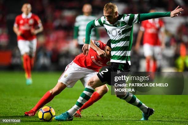 Benfica's Mexican forward Raul Jimenez vies with Sporting's French defender Jeremy Mathieu during the Portuguese league football match SL Benfica vs...