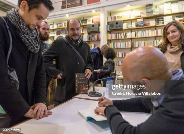 Spanish novelist and essayist Jorge Carrion signs copies of the Portuguese edition of his last book "Livrarias" at the end of his talk about it at...