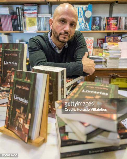 Spanish novelist and essayist Jorge Carrion seen behind copies of the Portuguese edition of his last book "Livrarias" at Ler Devagar bookstore in LX...