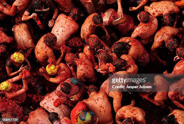 Revellers pelt each other with tomatoes during the world's biggest tomato fight at La Tomatina festival on August 26, 2009 in Bunol, Spain. More than...