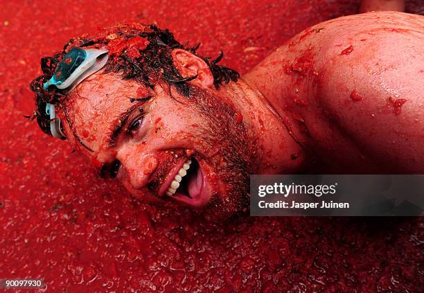 Reveller lays in tomato pulp during the world's biggest tomato fight at La Tomatina festival on August 26, 2009 in Bunol, Spain. More than 45000...