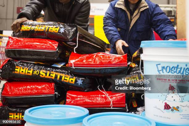 Customers grab packages of ice melter at a Home Depot Inc. Store in Boston, Massachusetts, U.S., on Wednesday, Jan. 3, 2018. The worst winter storm...
