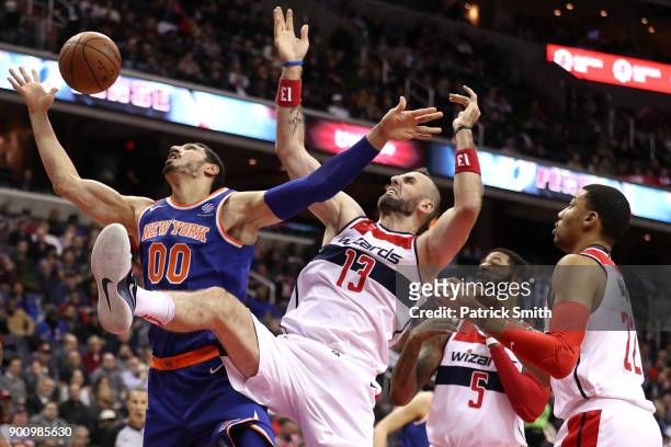 Enes Kanter of the New York Knicks and Marcin Gortat of the Washington Wizards battle for a rebound during the first half at Capital One Arena on...
