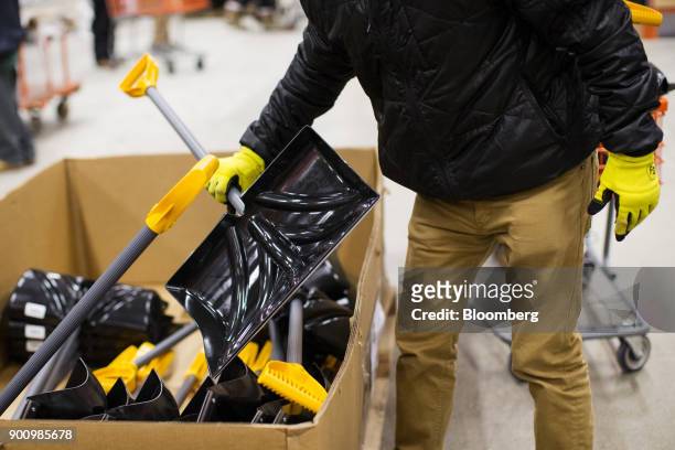 Customer grabs a snow shovel at a Home Depot Inc. Store in Boston, Massachusetts, U.S., on Wednesday, Jan. 3, 2018. The worst winter storm of the...