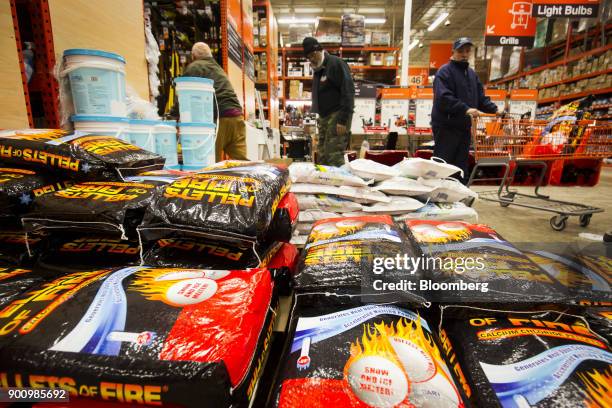 Customers browse packages of ice melter at a Home Depot Inc. Store in Boston, Massachusetts, U.S., on Wednesday, Jan. 3, 2018. The worst winter storm...