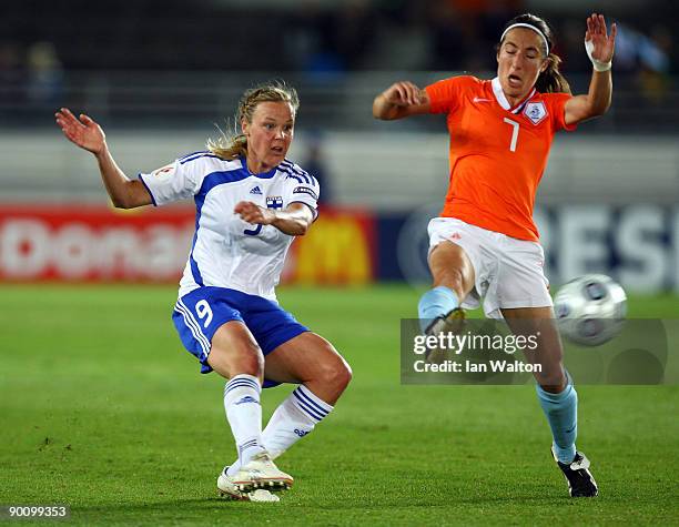 Annemieke Kiesel of the Netherlands tries to tackle Laura Elina Osterberg Kalmari of Finland during the UEFA Women's Euro 2009 group A preliminary...