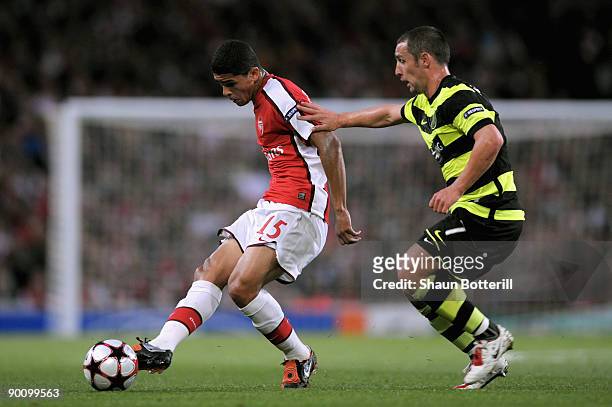 Denilson of Arsenal passes the ball as Scott McDonald of Celtic closes in during the UEFA Champions League 2nd qualifying round 2nd leg match between...