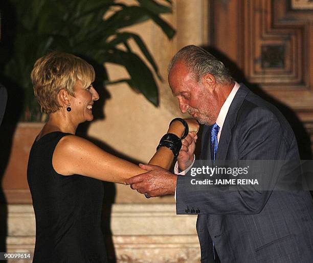 Spain's King Juan Carlos kisses Spanish Prime Minister's wife Sonsoles Espinosa at the Marivent Palace in Palma de Mallorca on August 26, 2009. The...