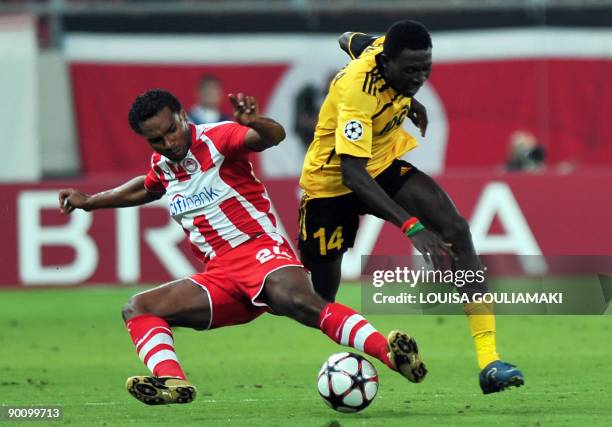 Olympiacos Piraeus Leonardo tackles FC Sheriff Tiraspol Benjamin Balima during their play-offs second leg Champions League match at the Karaiskaki...