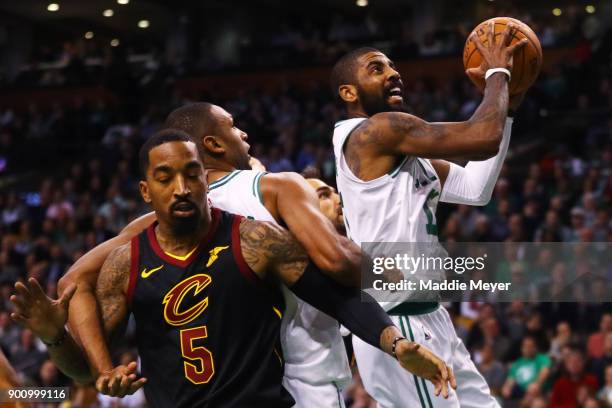 Kyrie Irving of the Boston Celtics takes a shot over JR Smith of the Cleveland Cavaliers during the first quarter at TD Garden on January 3, 2018 in...