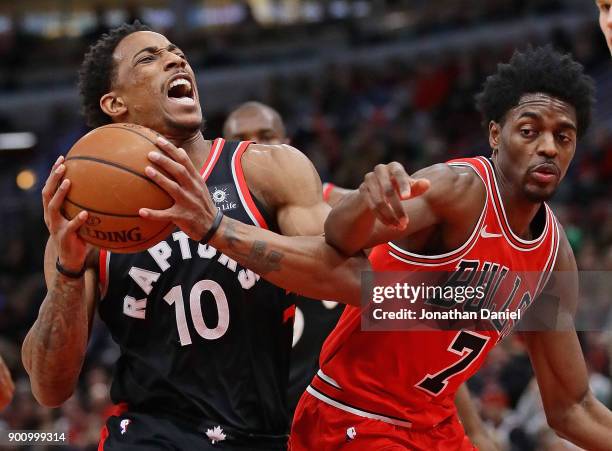 DeMar DeRozan of the Toronto Raptors drives against Justin Holiday of the Chicago Bulls at the United Center on January 3, 2018 in Chicago, Illinois....