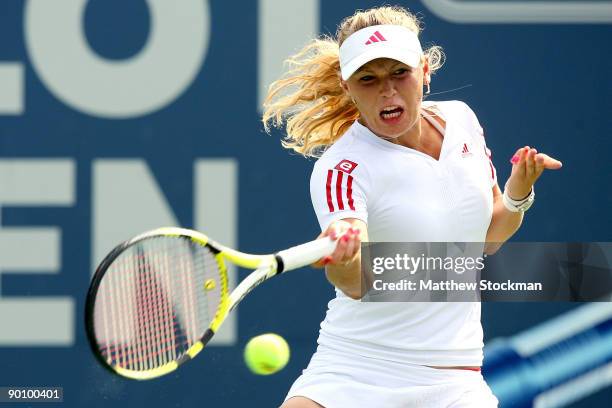 Caroline Wozniacki of Denmark returns a shot to Anastasia Pavlyuchenkova of Russia during the Pilot Pen Tennis tournament at the Connecticut Tennis...