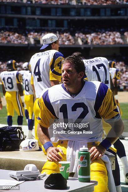 Quarterback Chris Miller of the Los Angeles Rams takes a rest on the bench during an exhibition game against the Oakland Raiders at the...