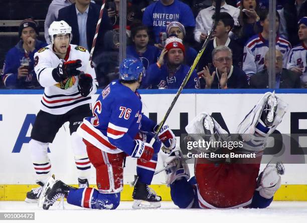 Nick Schmaltz of the Chicago Blackhawks celebrates his goal at 8:56 of the second period as Henrik Lundqvist of the New York Rangers tumbles out of...