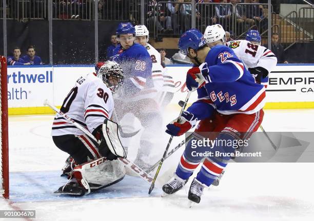 Jeff Glass of the Chicago Blackhawks makes the second period save as Kevin Shattenkirk of the New York Rangers looks for the rbeound at Madison...