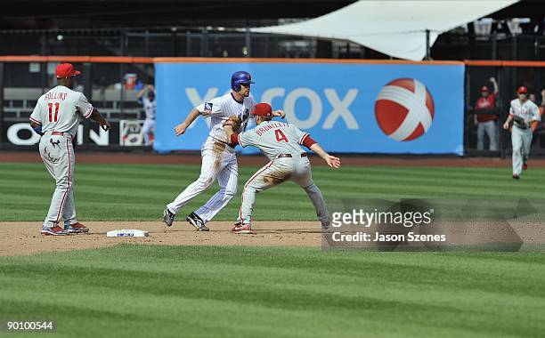 Second baseman Eric Bruntlett of the Philadelphia Phillies ends the game with an unassisted triple play as he tags out Daniel Murphy of the New York...