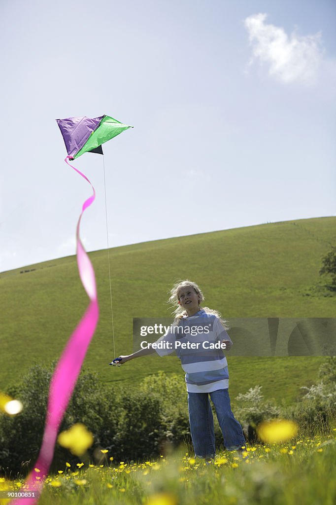 Girl outdoors flying kite