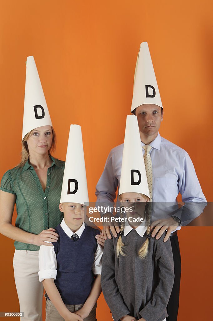 Family wearing dunces hats