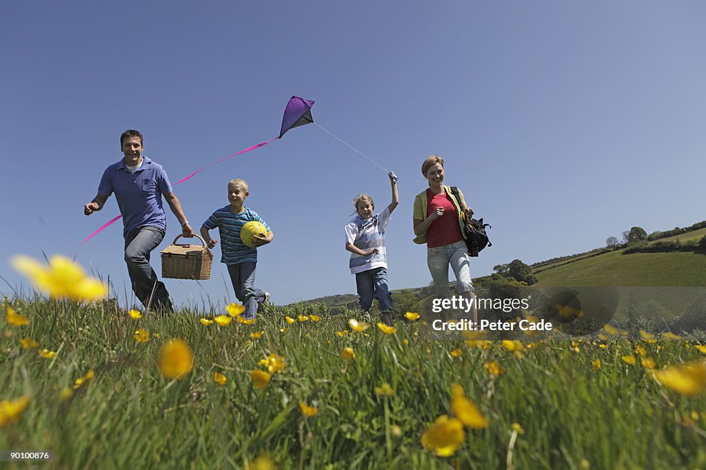 Family outdoors together flying kite