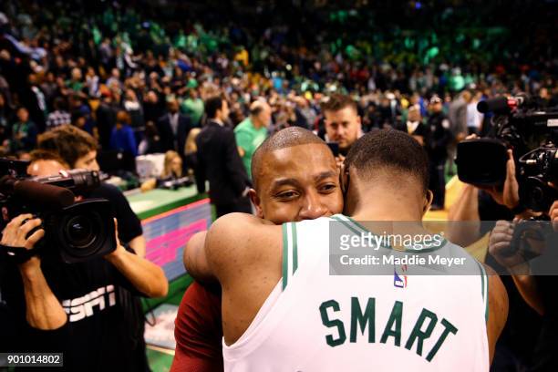 Isaiah Thomas of the Cleveland Cavaliers hugs Marcus Smart of the Boston Celtics after the Celtics defeat the Cavaliers 102-88 at TD Garden on...