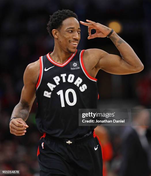 DeMar DeRozan of the Toronto Raptors signals to teammates after hitting a three point shot on his way to a game-high 35 points against the Chicago...