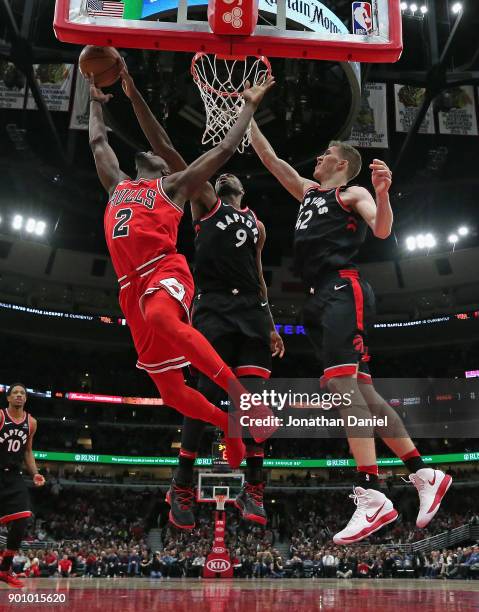 Serge Ibaka of the Toronto Raptors blocks a shot by Jerian Grant of the Chicago Bulls as Jakob Poeltl defends at the United Center on January 3, 2018...
