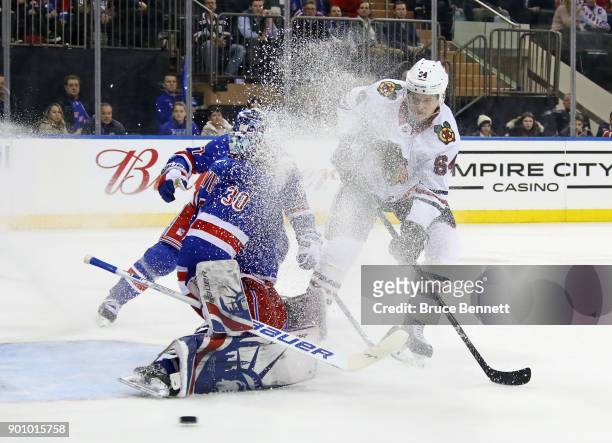 David Kampf of the Chicago Blackhawks is stopped by Henrik Lundqvist of the New York Rangers during the third period at Madison Square Garden on...