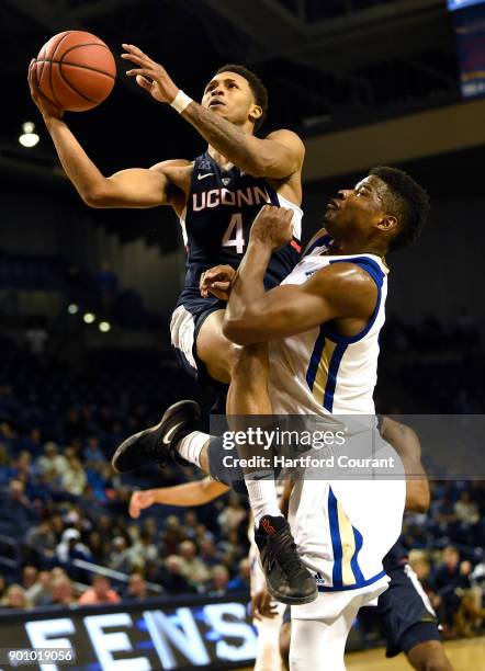 Connecticut's Jalen Adams gets to the basket against Tulsa's Junior Etou at Reynolds Center in Tulsa, Okla., on Wednesday, Jan. 3, 2018. Tulsa won,...