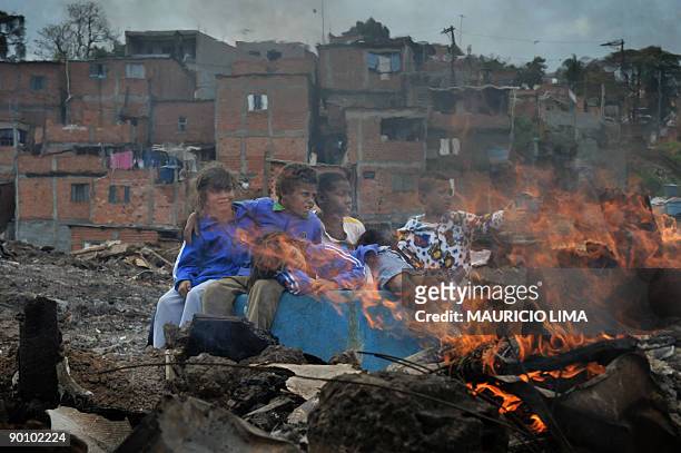 Brazilian homeless children take a break while playing on the land they were evicted from at Capao Redondo shantytown, southern outskirts of Sao...