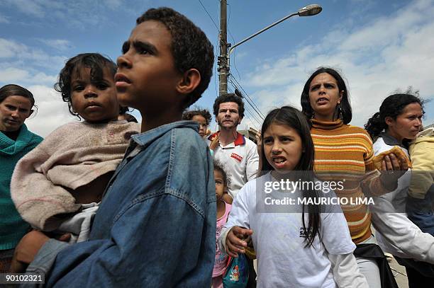 Brazilian homeless families queue up to get food in front of the land they were evicted from, at Capao Redondo shantytown, southern outskirts of Sao...