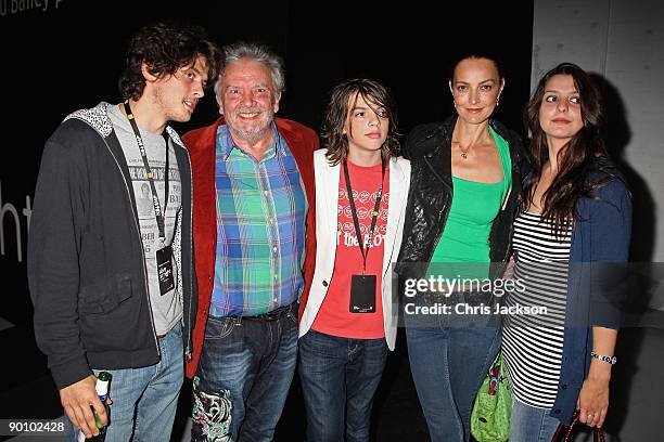 Photographer David Bailey , his wife Catherine Bailey and their family pose for a photograph as they attend the Alive at Night private view and...