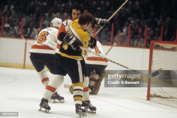 Joe Watson of the Philadelphia Flyers defends against Gregg Sheppard of the Boston Bruins during the 1974 Stanley Cup Finals in May 1974 at the...