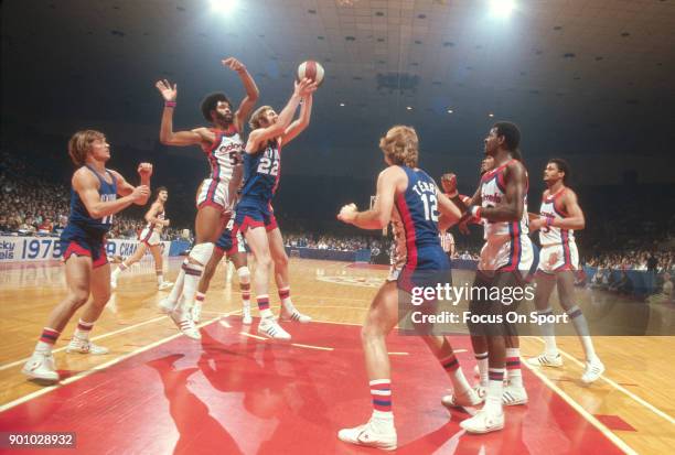 Jim Eakins of the New Jersey Nets grabs a rebound in front of Artis Gilmore of the Kentucky Colonels during an ABA basketball game circa 1976 at...