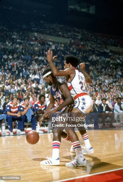 Jimmy Walker of the Kansas City Kings is closely guarded by Dave Bing of the Washington Bullets during an NBA basketball game circa 1975 at the...