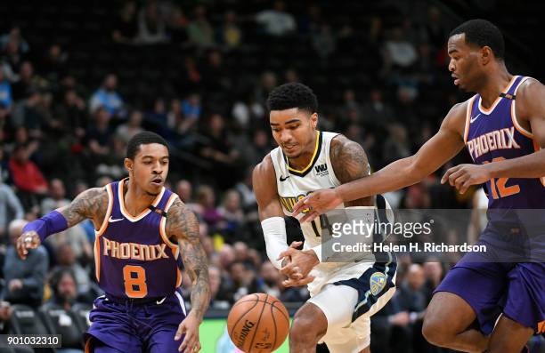 Denver Nuggets guard Gary Harris, #14, loses the ball to Phoenix Suns' guards Tyler Ulis, #8, left, and T.J. Warren, #12, right, during the first...
