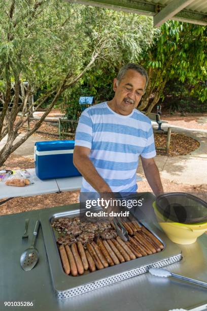australian aboriginal man cooking a bbq for his family - bbq australia stock pictures, royalty-free photos & images