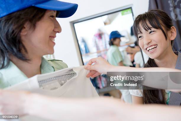 young man and teenage girl in clothing store - girl changing room shop stock pictures, royalty-free photos & images