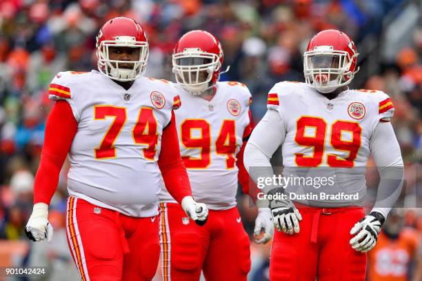 Kansas City Chiefs defensive players, defensive tackle Justin Hamilton, defensive tackle Jarvis Jenkins, and defensive end Rakeem Nunez-Roches stand...