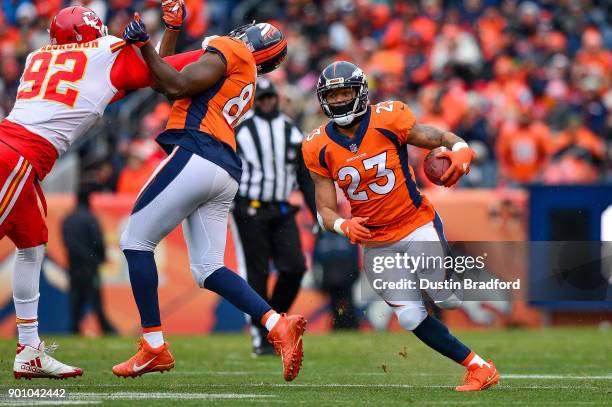 Running back Devontae Booker of the Denver Broncos rushes against the Kansas City Chiefs at Sports Authority Field at Mile High on December 31, 2017...