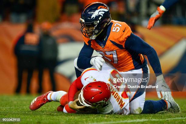 Quarterback Patrick Mahomes of the Kansas City Chiefs is sacked by defensive end DeMarcus Walker of the Denver Broncos at Sports Authority Field at...