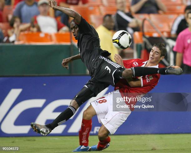 Julius James of D.C. United crashes into Isaac Brizuela of CD Toluca during a CONCACAF Champions League match at RFK Stadium on August 26, 2009 in...