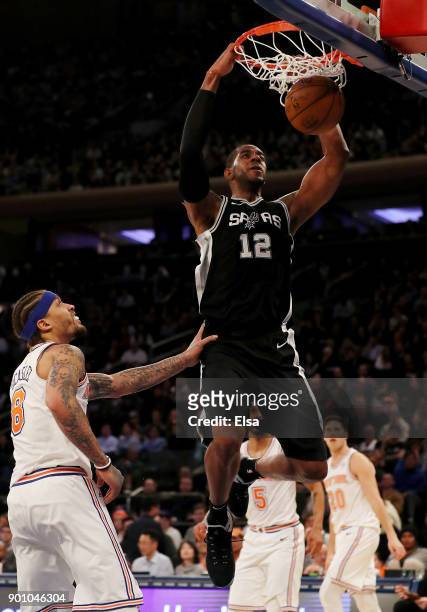 LaMarcus Aldridge of the San Antonio Spurs dunks the ball as Michael Beasley of the New York Knicks defends in the second half at Madison Square...