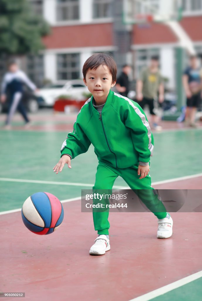 Cute asia children playing basketball