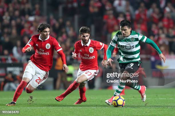 Sporting's midfielder Marcos Acuna from Argentina vies with Benfica's Croatian forward Filip Krovinovic and Benfica's Portuguese midfielder Rafa...