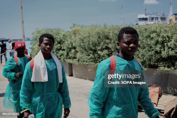 African refugees seen leaving from the ship after being rescued. About 1500 african refugees land in Naples from Vos Prudence, a rescue boat of...